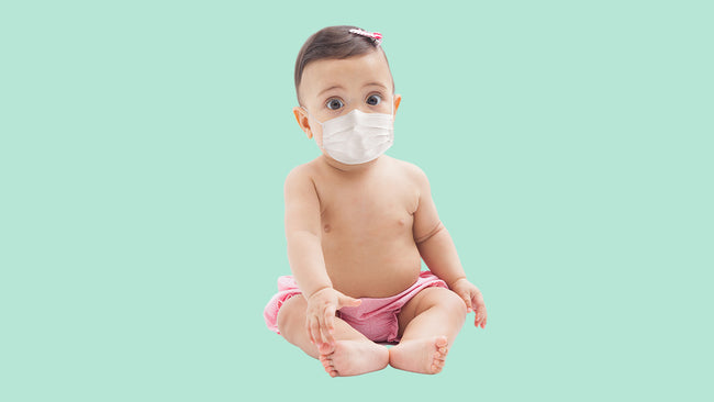 A baby with a mask for precaution from covid
